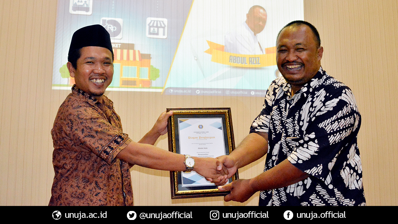 Vice Rector III gives a souvenir to Bapak Aziz as a keynote speaker